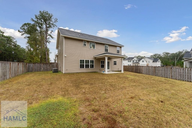 rear view of house featuring a lawn, a patio area, and central AC