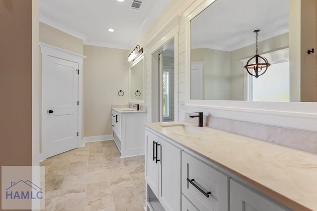 bathroom featuring two vanities, a chandelier, a sink, and visible vents
