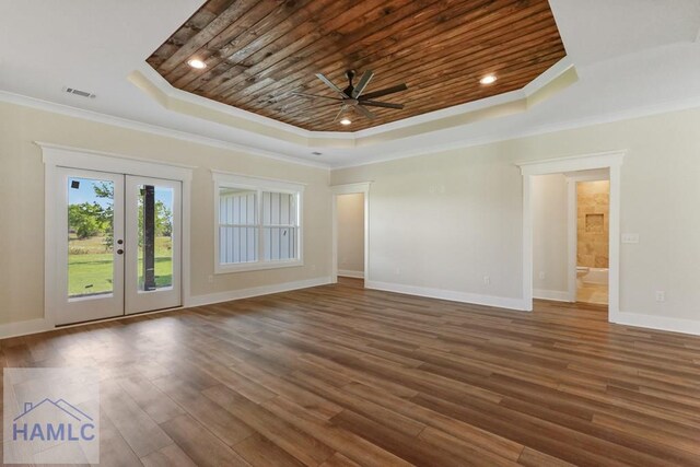 unfurnished living room with a ceiling fan, wood ceiling, french doors, a tray ceiling, and visible vents