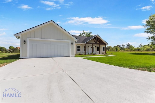 modern farmhouse with board and batten siding, an attached garage, a front lawn, and driveway
