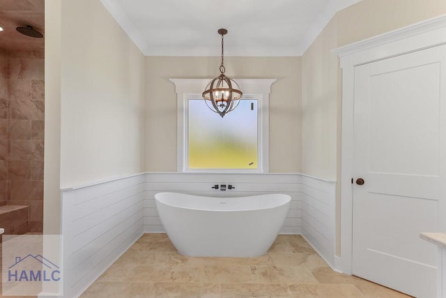 bathroom featuring a soaking tub, walk in shower, a notable chandelier, and a wainscoted wall