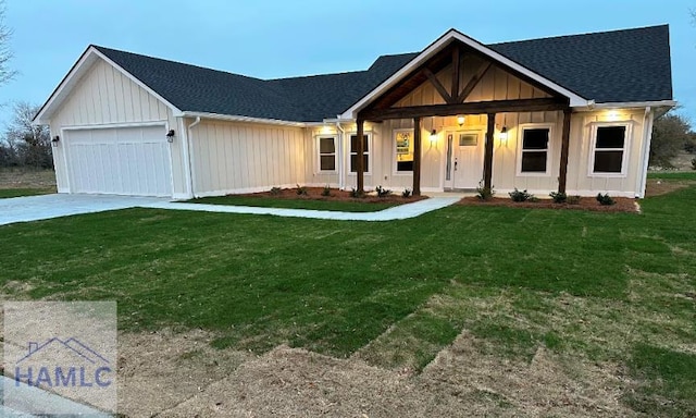 modern inspired farmhouse with an attached garage, roof with shingles, a front yard, and concrete driveway
