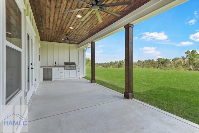 view of patio with a grill, a ceiling fan, exterior kitchen, and a sink