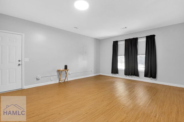 spare room with wood-type flooring