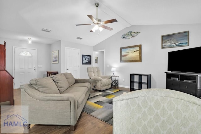 living room featuring ceiling fan, wood-type flooring, and vaulted ceiling