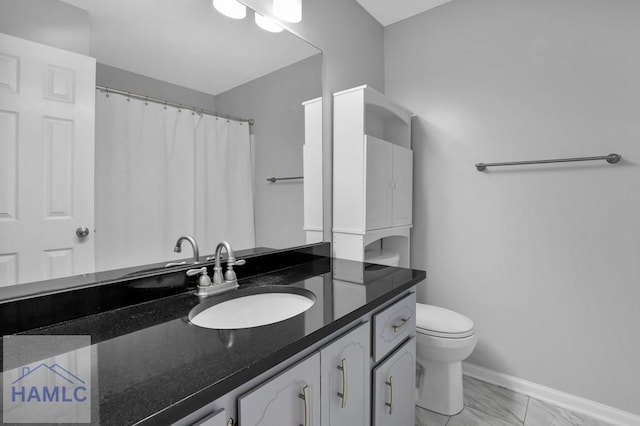 bathroom with curtained shower, vanity, and toilet