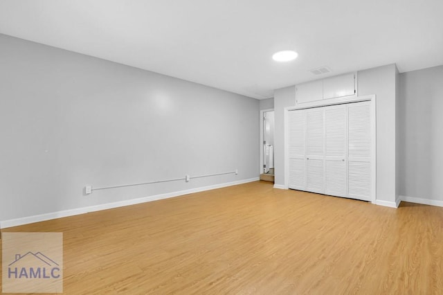 unfurnished bedroom with light hardwood / wood-style floors and a closet