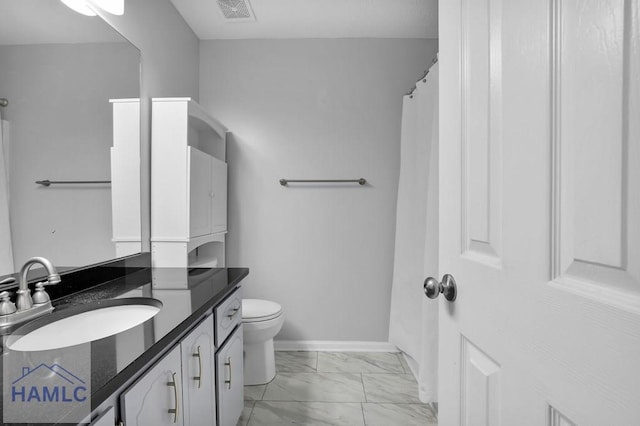 bathroom with vanity and toilet