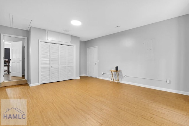 unfurnished bedroom with wood-type flooring and a closet