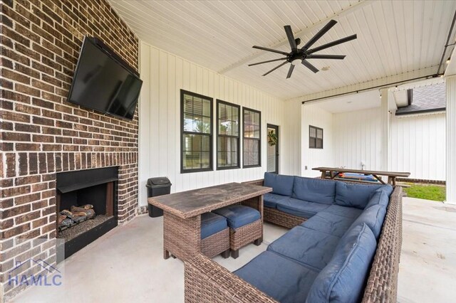 view of patio / terrace featuring an outdoor living space with a fireplace and ceiling fan