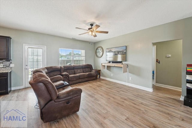 91 Thomas Way SE, Ludowici, GA 31316 - living room with ceiling fan, light wood finished floors, and a textured ceiling