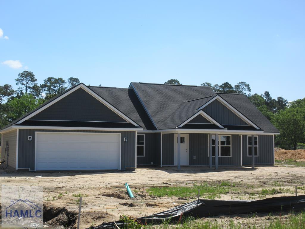 view of front of property with an attached garage, a porch, and roof with shingles