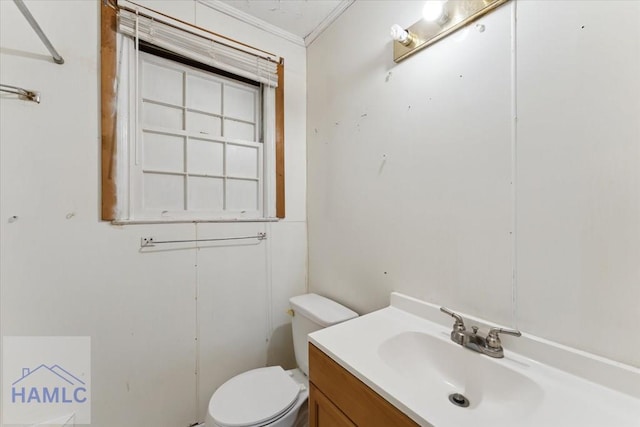 bathroom with vanity, toilet, and ornamental molding