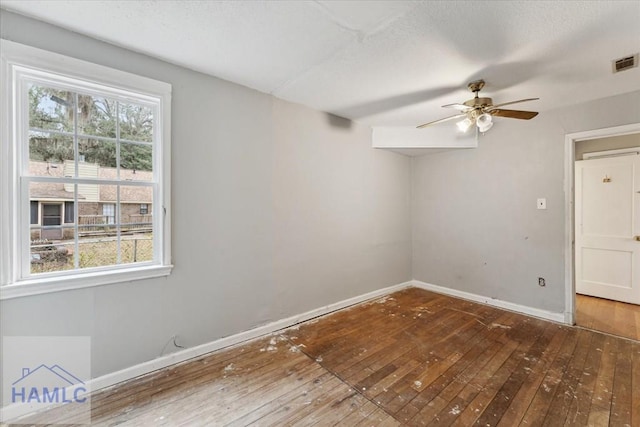 unfurnished room featuring ceiling fan and dark hardwood / wood-style flooring