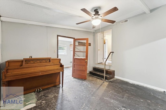 misc room featuring ceiling fan and beamed ceiling