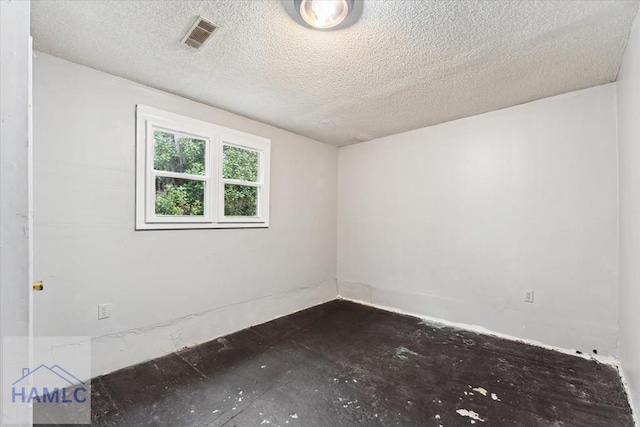 empty room with a textured ceiling