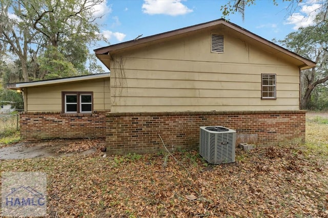 view of side of home featuring cooling unit