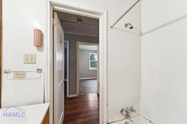 bathroom featuring vanity, bathing tub / shower combination, and wood-type flooring