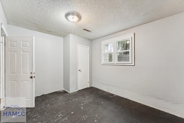 spare room featuring a textured ceiling