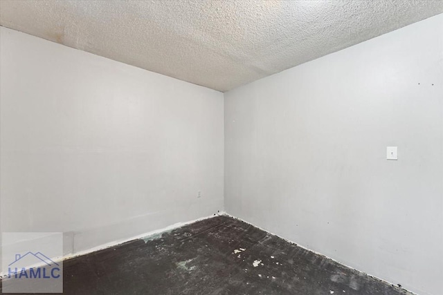 spare room with a textured ceiling