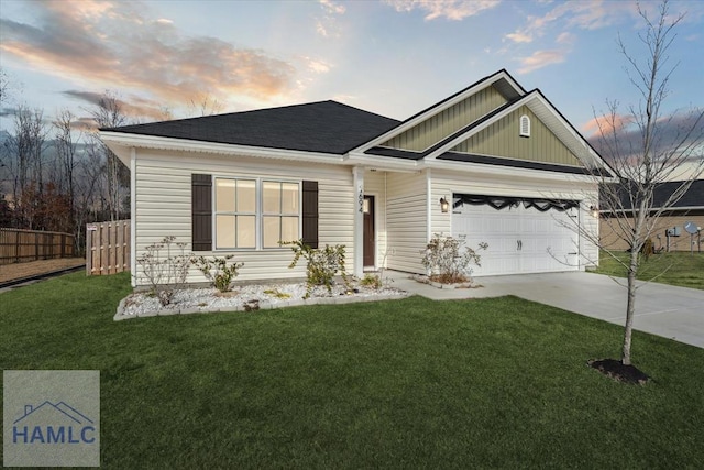 ranch-style house featuring a garage, a yard, fence, and driveway