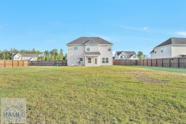 rear view of property featuring a yard