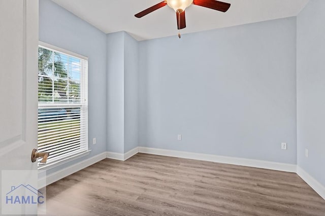 spare room with ceiling fan, baseboards, and wood finished floors