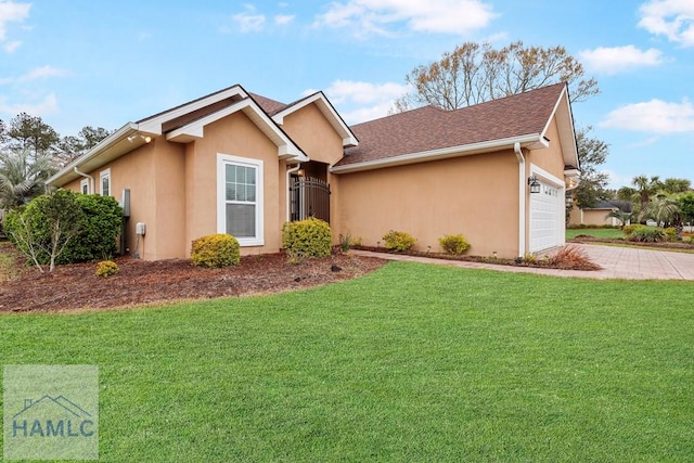 ranch-style home featuring a front lawn, roof with shingles, stucco siding, driveway, and an attached garage