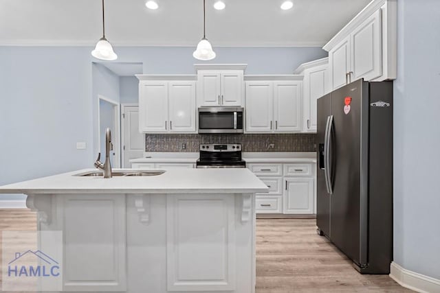 kitchen featuring light countertops, white cabinets, tasteful backsplash, and stainless steel appliances