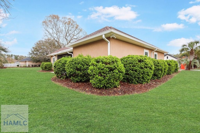 view of home's exterior featuring a lawn and stucco siding