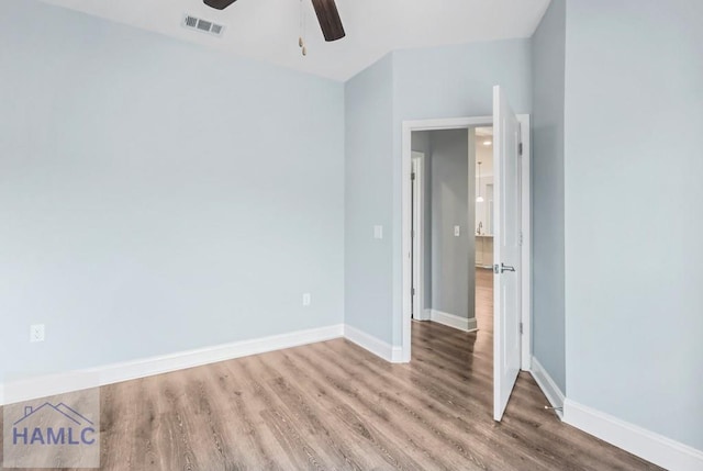 unfurnished bedroom with a ceiling fan, wood finished floors, and baseboards