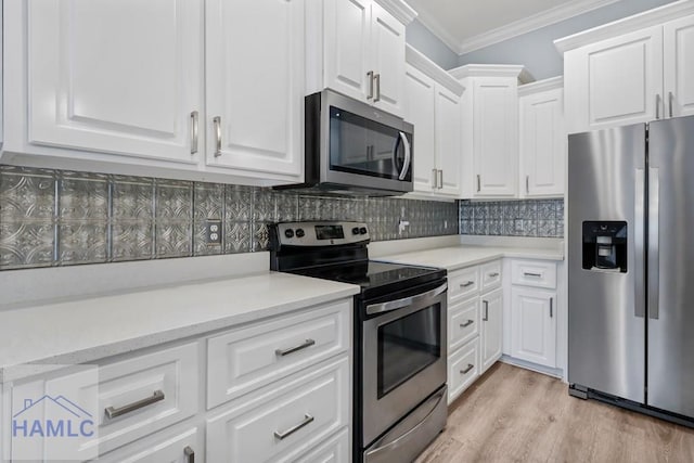 kitchen featuring decorative backsplash, appliances with stainless steel finishes, white cabinets, and crown molding