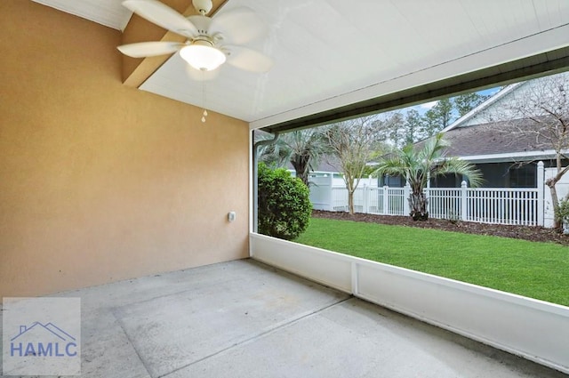 unfurnished sunroom with a ceiling fan