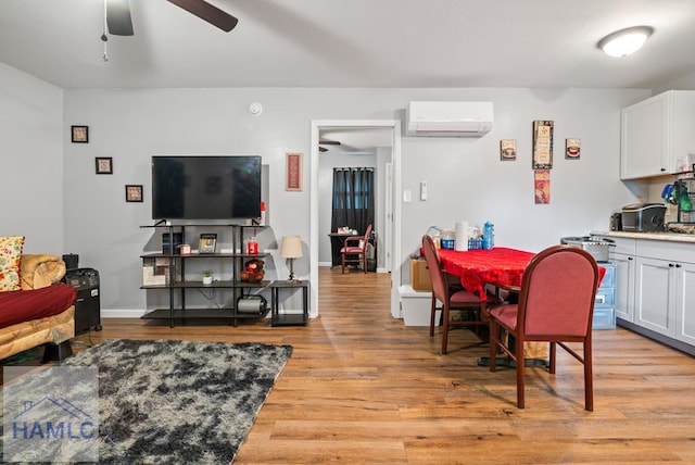 206 W Jones Ave, Statesboro, GA 30458 - living area featuring an AC wall unit, light wood-type flooring, and a ceiling fan