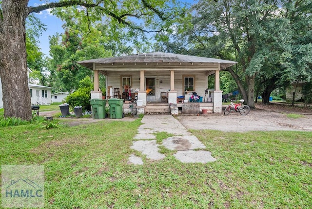 206 W Jones Ave, Statesboro, GA 30458 - rear view of house with a porch and a lawn