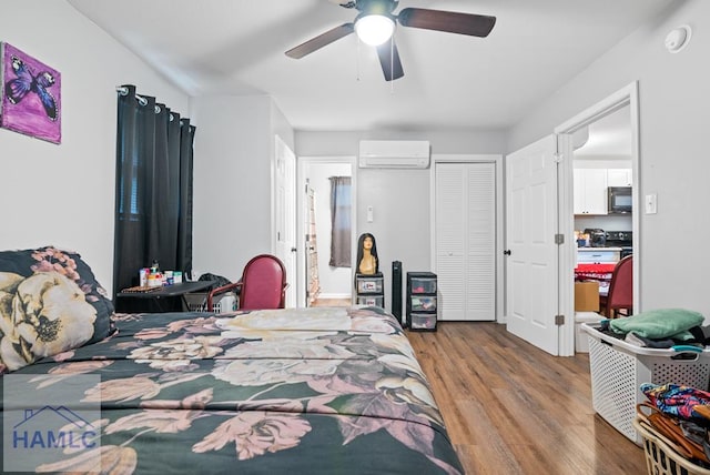 206 W Jones Ave, Statesboro, GA 30458 - bedroom with a wall unit AC, wood finished floors, and a ceiling fan