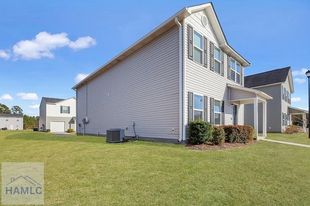 view of side of home with central air condition unit and a yard