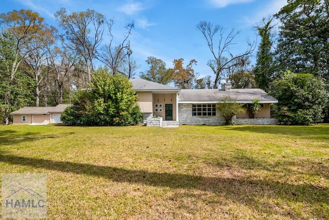 view of front of house featuring a chimney and a front lawn