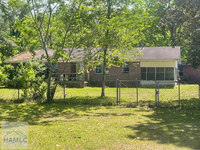 exterior space with a lawn, brick siding, and fence private yard