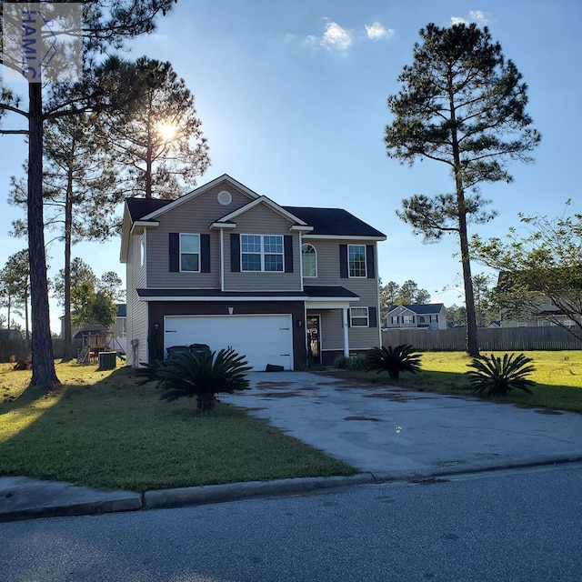 view of front of property featuring a front yard and a garage