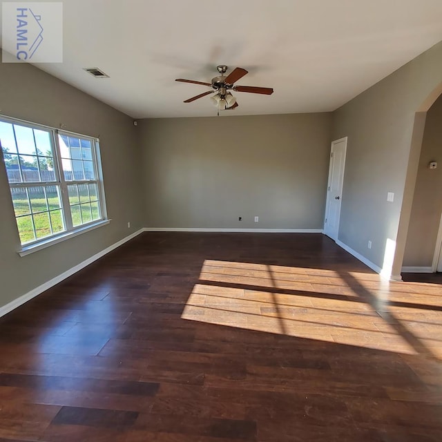 spare room featuring ceiling fan and dark hardwood / wood-style flooring