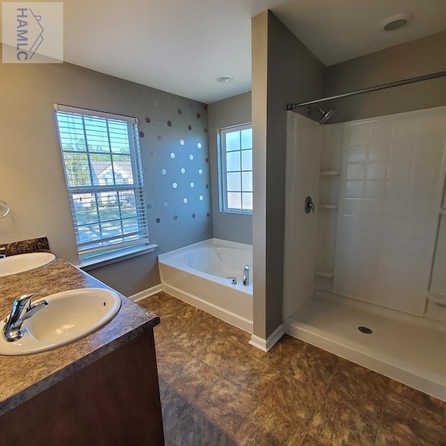 bathroom with vanity and independent shower and bath