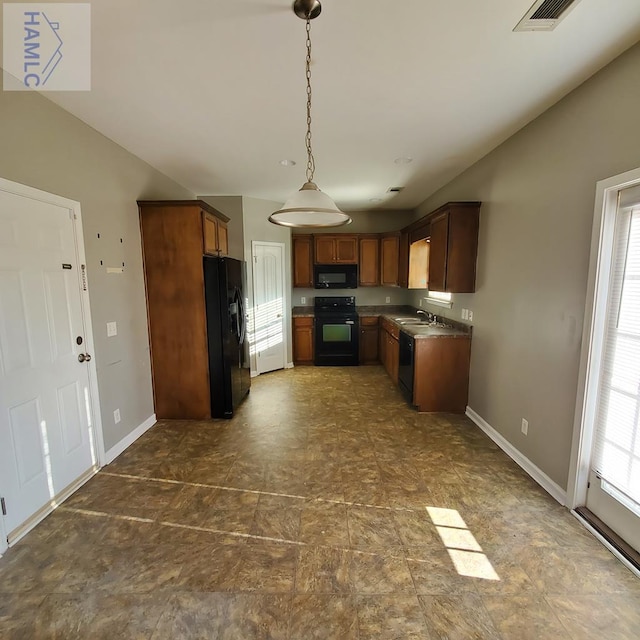 kitchen with black appliances, pendant lighting, and sink