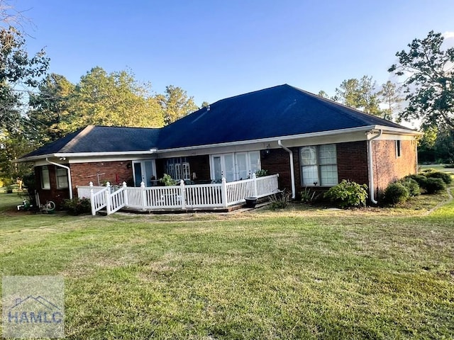 back of house with a yard and a deck