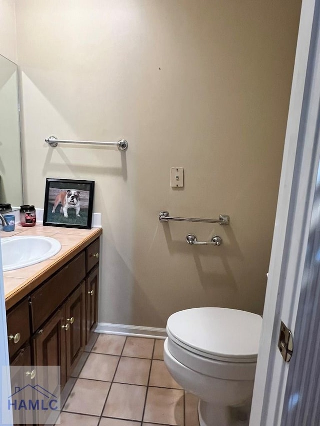 bathroom featuring toilet, vanity, and tile patterned floors