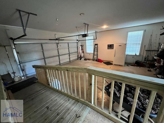 garage featuring white fridge and a garage door opener