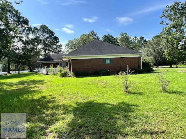 view of side of property with a yard