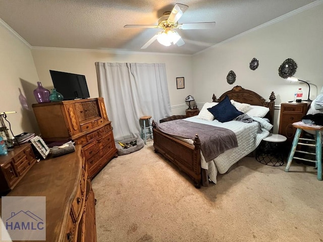 carpeted bedroom featuring ceiling fan, ornamental molding, and a textured ceiling