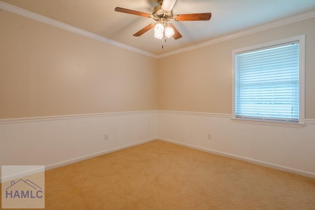 unfurnished room featuring ceiling fan, crown molding, and light carpet