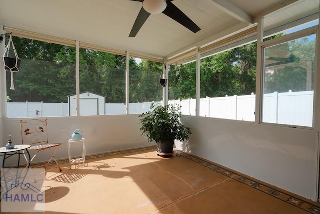 unfurnished sunroom with a ceiling fan and a wealth of natural light